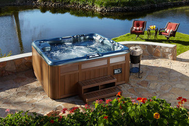 Photo of a traditional back hot tub in San Francisco with natural stone paving.