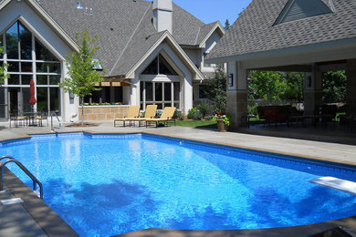 Mid-sized transitional backyard concrete paver and rectangular lap pool photo in Minneapolis