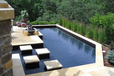 Example of a mid-sized minimalist backyard stone and rectangular lap pool design in Minneapolis