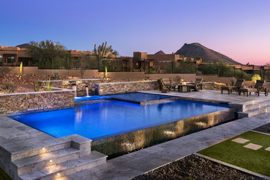 Pool fountain - mid-sized contemporary backyard stone and custom-shaped infinity pool fountain idea in Phoenix