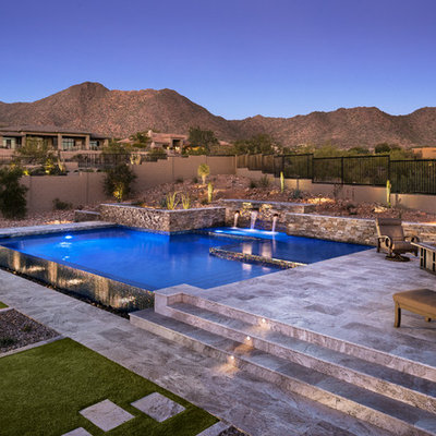 Inspiration for a mid-sized southwestern backyard stone and custom-shaped infinity pool fountain remodel in Phoenix