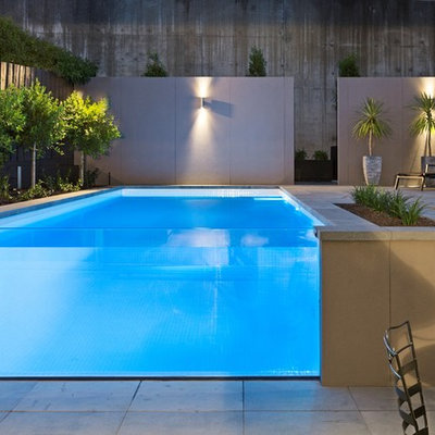 Mid-sized minimalist backyard stone and rectangular aboveground pool photo in Melbourne