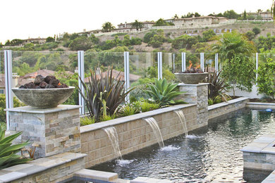 Inspiration for a mid-sized timeless backyard stone and l-shaped lap pool fountain remodel in Orange County