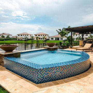 Swim Spa With Custom Fire Bowls and Outdoor Kitchen in Cooper City, Florida