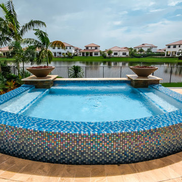 Swim Spa With Custom Fire Bowls and Outdoor Kitchen in Cooper City, Florida
