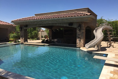 Water slide - large transitional backyard stone and rectangular lap water slide idea in Phoenix