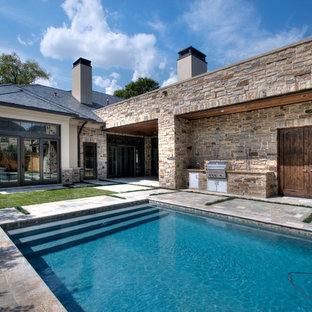 This is an example of a mediterranean rectangular pool in Houston with natural stone pavers.