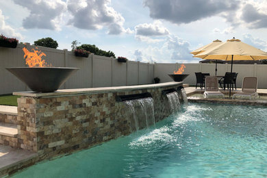 Design ideas for a medium sized world-inspired back kidney-shaped swimming pool in Orlando with natural stone paving.