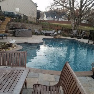 Swimming pool project with retaining walls and patio