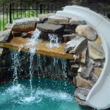 Swimming Pool with Slides and Waterfall Stone Features