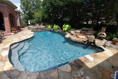 Inspiration for a large craftsman backyard stone and custom-shaped lap hot tub remodel in Nashville
