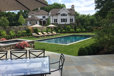Mid-sized elegant backyard concrete paver and rectangular lap hot tub photo in New York