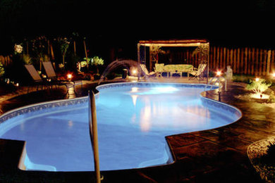 Pool - large backyard custom-shaped pool idea in St Louis