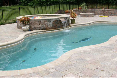 Mid-sized mountain style backyard stone and custom-shaped natural pool fountain photo in New York