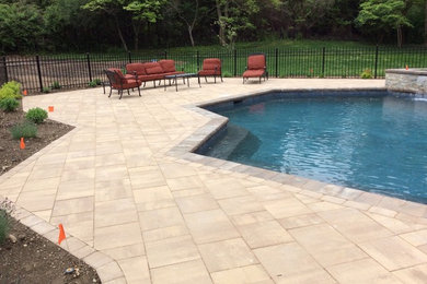 Example of a trendy brick pool design in New York