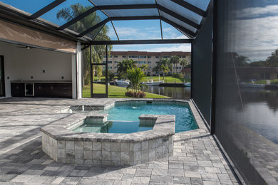 Inspiration for a mid-sized stone pool remodel in Miami