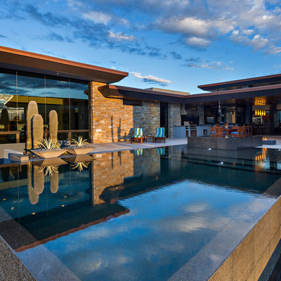 Example of a southwest backyard custom-shaped aboveground pool fountain design in Other