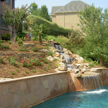 Terraced hillside and water feature into a gunite pool