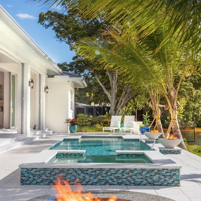 Trendy backyard concrete paver and rectangular hot tub photo in Tampa