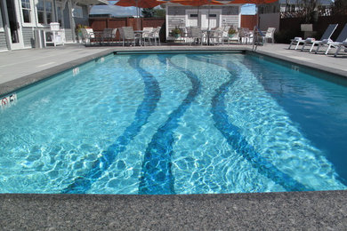 Mid-sized beach style backyard concrete paver and rectangular pool fountain photo in Providence