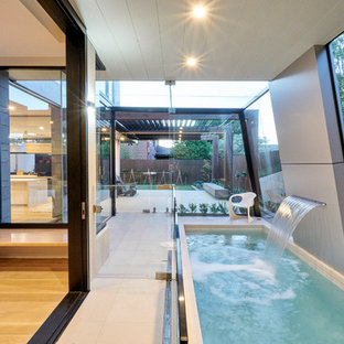Inspiration for a contemporary indoor rectangular lap pool in Melbourne with a water feature and tile.