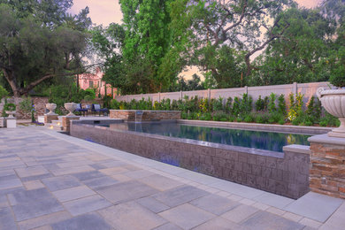 Diseño de piscinas y jacuzzis mediterráneos rectangulares en patio trasero con adoquines de hormigón
