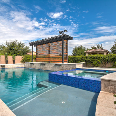 Inspiration for a large mediterranean backyard concrete paver and custom-shaped lap pool fountain remodel in Phoenix