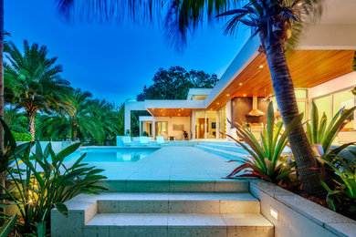Huge trendy backyard rectangular pool photo in Tampa