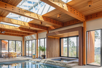 This is an example of a rustic indoor rectangular hot tub in Other.