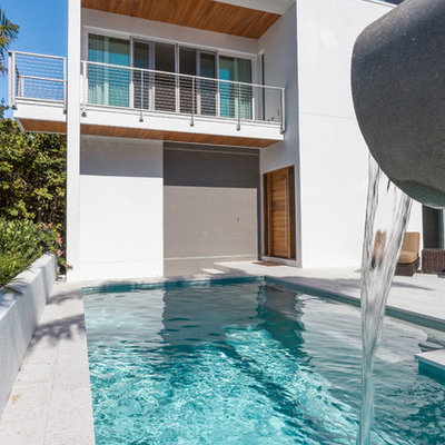 Pool fountain - mid-sized contemporary backyard concrete paver and rectangular natural pool fountain idea in Tampa