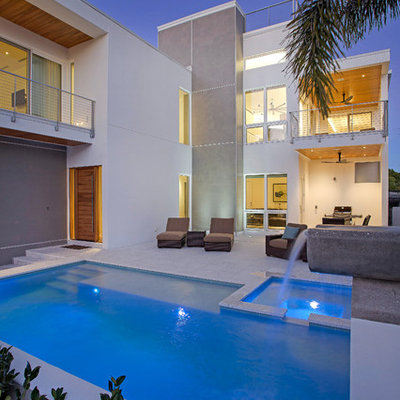 Inspiration for a mid-sized contemporary backyard concrete paver and rectangular natural pool fountain remodel in Tampa