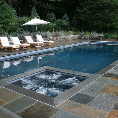 Elegant stone and rectangular pool photo in New York