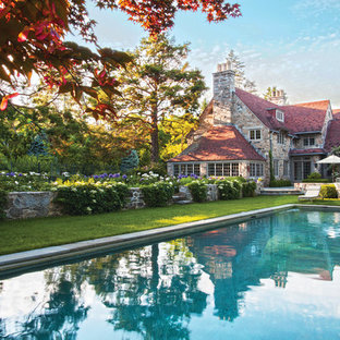 Photo of a mid-sized arts and crafts backyard rectangular lap pool in New York with natural stone pavers.