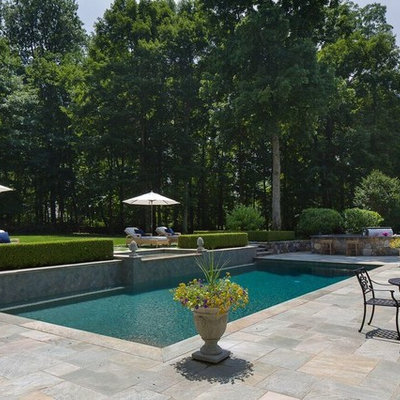 Inspiration for a mid-sized transitional backyard stone and rectangular lap hot tub remodel in New York
