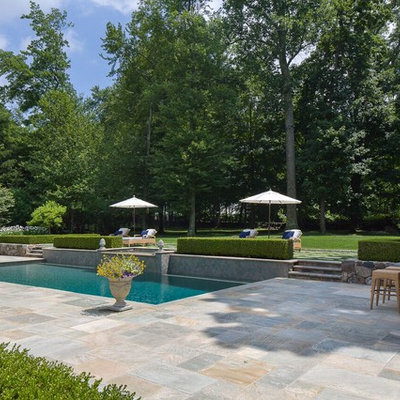 Inspiration for a mid-sized transitional backyard stone and rectangular lap hot tub remodel in New York