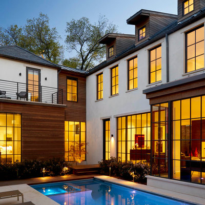 Inspiration for a mid-sized transitional backyard concrete paver and rectangular lap pool remodel in Dallas
