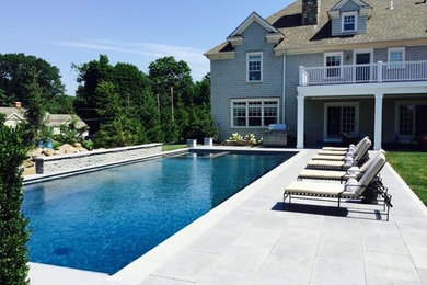 Example of a large classic backyard concrete paver and rectangular lap hot tub design in New York