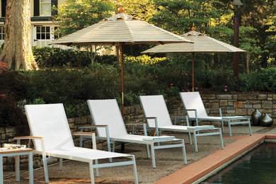 Travira Chaise Lounges with Natural Tekwood Arms on Pool Deck