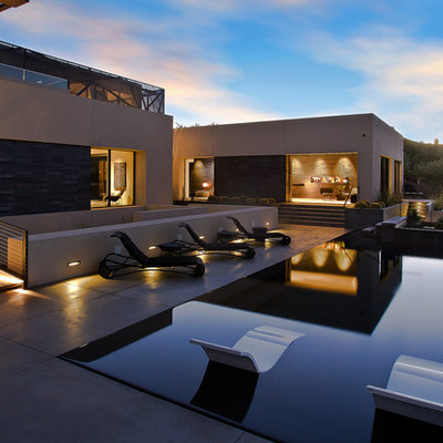Trendy backyard rectangular infinity pool photo in Las Vegas