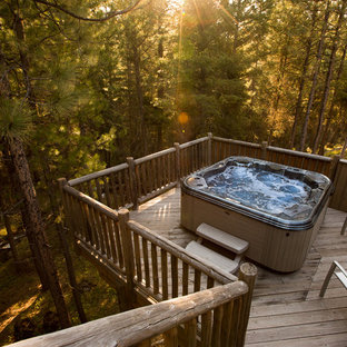 Photo of a small country backyard rectangular aboveground pool in Other with a hot tub and decking.