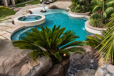 Tropical Beach Entry Pool & Spa with a Rock Slide & Grotto