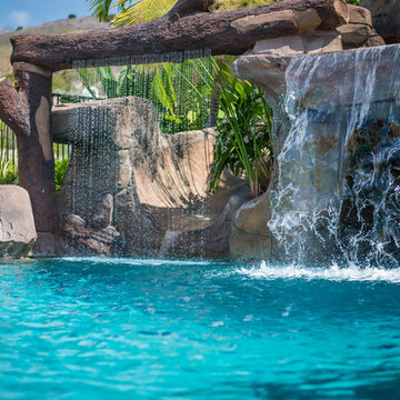 Tropical Beach Entry Pool & Spa with a Rock Slide & Grotto