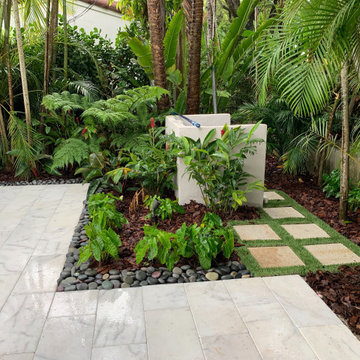 Tropical Foliage landscape design to hide pool pump