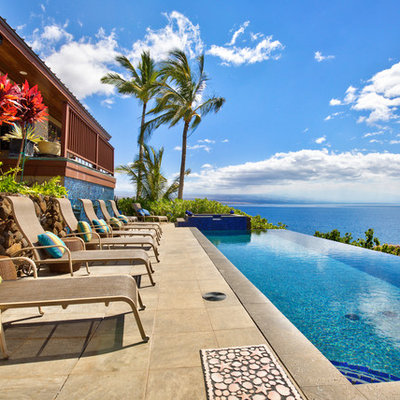 Island style backyard rectangular infinity pool photo in Hawaii