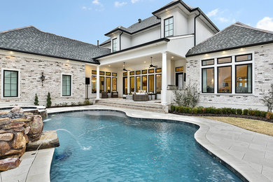 Design ideas for a classic back custom shaped swimming pool in New Orleans with a water feature.