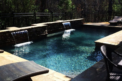 Small elegant backyard custom-shaped natural pool fountain photo in Atlanta with decking