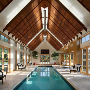 Design ideas for a large contemporary indoor rectangular lap pool in Cedar Rapids with a pool house and tile.