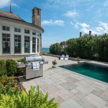 Unilock Natural Stone patio and pool with an ocean view