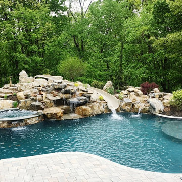 Upper Saucon large custom pool with boulder waterfall, slide, sunshelf, and spa