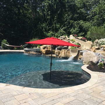 Upper Saucon large custom pool with boulder waterfall, slide, sunshelf, and spa